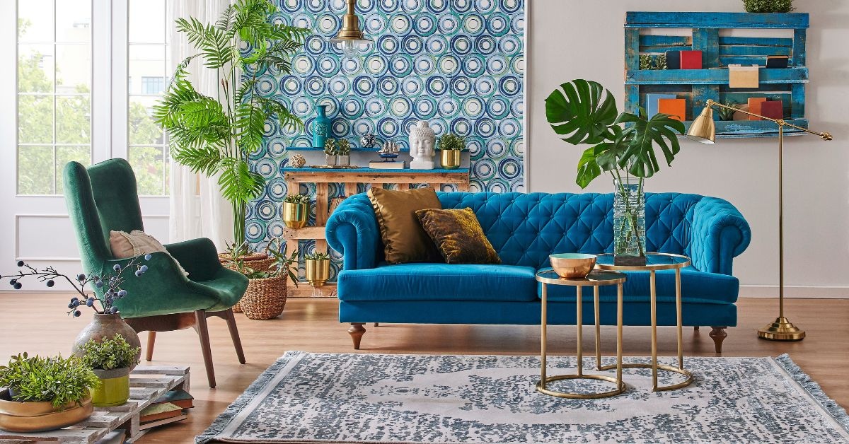 one green accent chair and Royal-blue loveseat in a room.