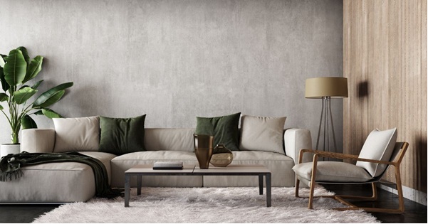 Two young ladies talking one holding a book another with box in a collge dorm