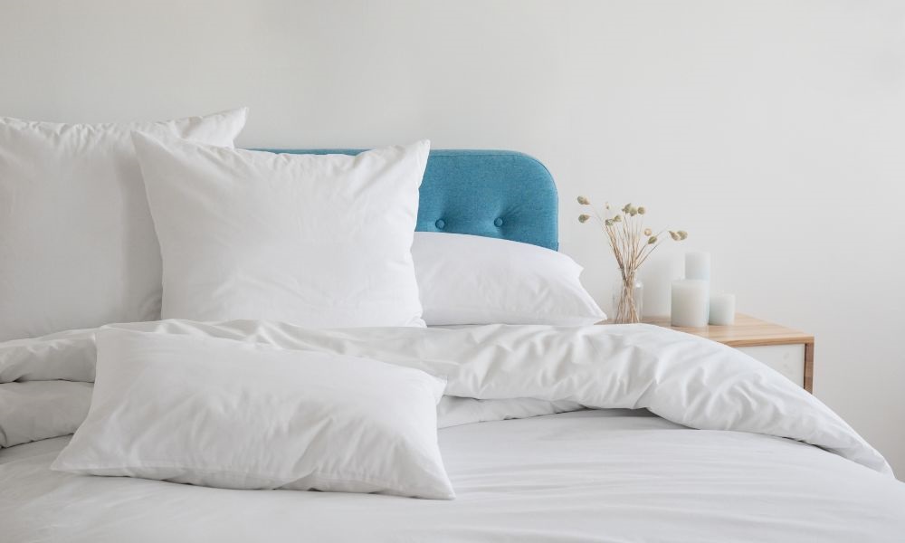 A white pillow and white blanket