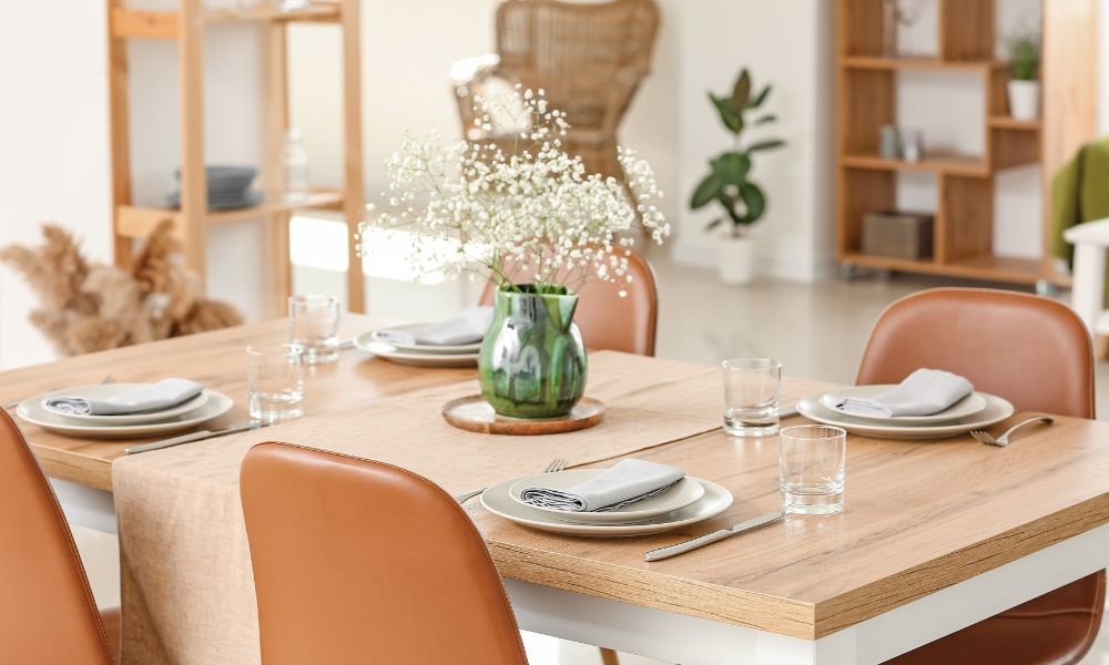 A beige dining room table set with comfortable chairs