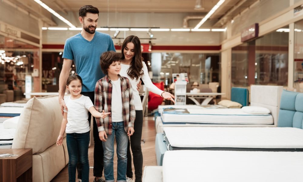 A couple and two children looking and walking in the mattress store