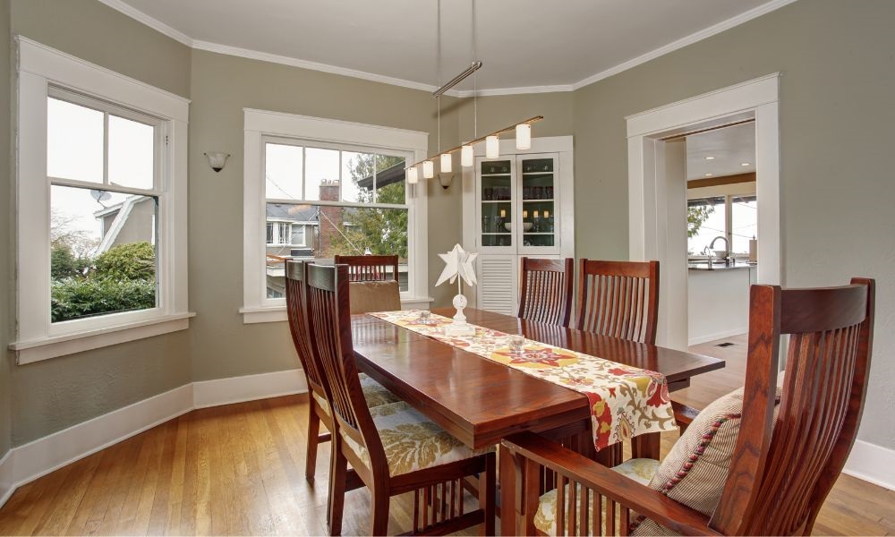 Image with a dining room in front of several windows
